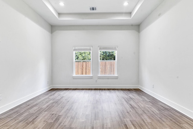 240 Rosemary Dr, Azle, TX 76020 - empty room featuring a tray ceiling, wood finished floors, baseboards, and recessed lighting