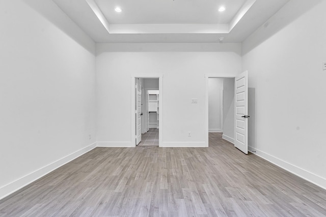 240 Rosemary Dr, Azle, TX 76020 - unfurnished bedroom featuring a tray ceiling, wood finished floors, recessed lighting, baseboards, and a spacious closet