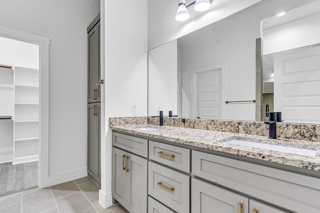 240 Rosemary Dr, Azle, TX 76020 - bathroom with double vanity, a closet, a shower stall, and baseboards