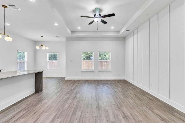 240 Rosemary Dr, Azle, TX 76020 - unfurnished living room featuring wood finished floors, a ceiling fan, a raised ceiling, a chandelier, and recessed lighting