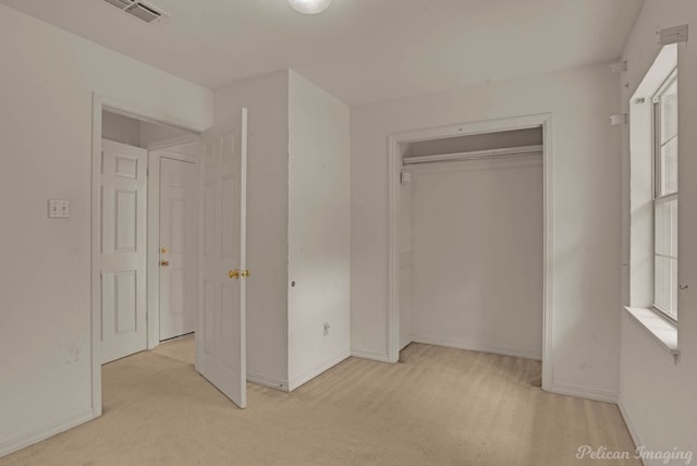 605 Erie St, Shreveport, LA 71106 - unfurnished bedroom featuring light colored carpet, baseboards, and a closet