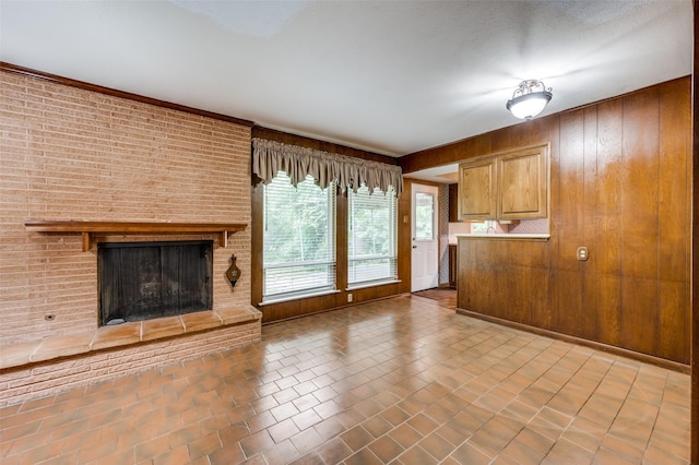 1122 Gloucester Ct N, Irving, TX 75062 - unfurnished living room featuring a brick fireplace and wood walls