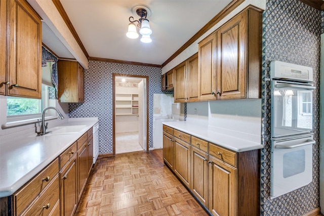 1122 Gloucester Ct N, Irving, TX 75062 - kitchen featuring wallpapered walls, a sink, white appliances, ornamental molding, and brown cabinets