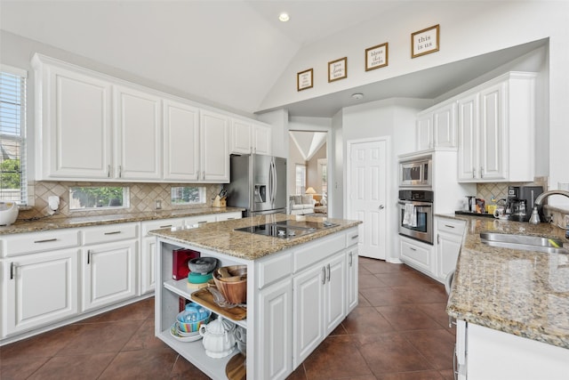 1908 Longfellow Ln, Flower Mound, TX 75028 - kitchen with appliances with stainless steel finishes, a sink, a center island, lofted ceiling, and white cabinetry