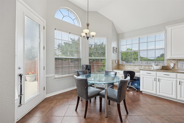 1908 Longfellow Ln, Flower Mound, TX 75028 - dining area featuring dark tile patterned flooring, a chandelier, baseboards, and high vaulted ceiling