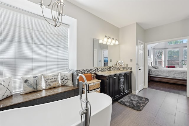 1908 Longfellow Ln, Flower Mound, TX 75028 - ensuite bathroom with a chandelier, a soaking tub, and vanity