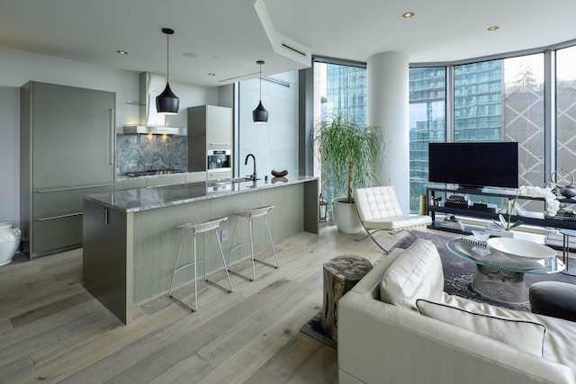 2900 Mckinnon St Unit 604, Dallas, TX 75201 - living room featuring a wall of windows, light wood finished floors, and recessed lighting