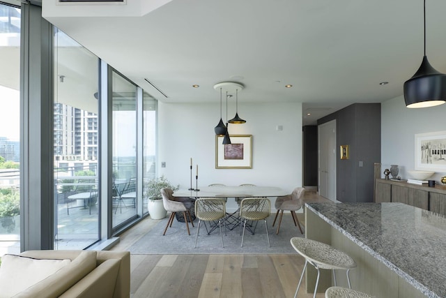 2900 Mckinnon St Unit 604, Dallas, TX 75201 - dining room with light wood-style flooring, floor to ceiling windows, and recessed lighting