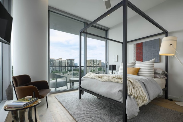 2900 Mckinnon St Unit 604, Dallas, TX 75201 - bedroom with a view of city, light wood-style flooring, and floor to ceiling windows