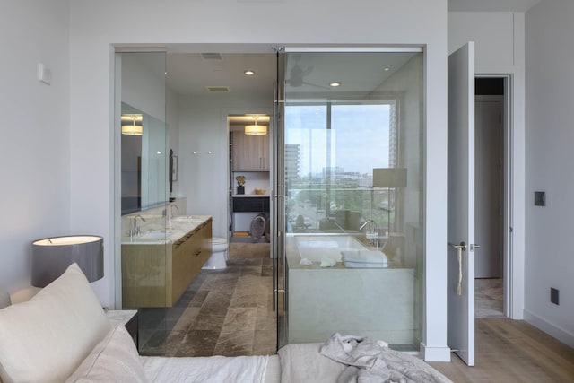 2900 Mckinnon St Unit 604, Dallas, TX 75201 - bathroom with vanity, toilet, and an enclosed shower