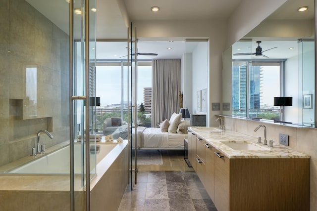 2900 Mckinnon St Unit 604, Dallas, TX 75201 - ensuite bathroom featuring ceiling fan, double vanity, a bath, a shower with shower door, and recessed lighting