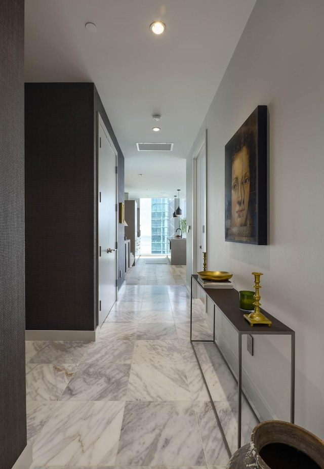 2900 Mckinnon St Unit 604, Dallas, TX 75201 - hall with light marble finish flooring, recessed lighting, and baseboards