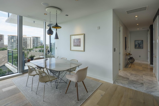 2900 Mckinnon St Unit 604, Dallas, TX 75201 - dining area with a wall of windows, baseboards, a city view, and recessed lighting