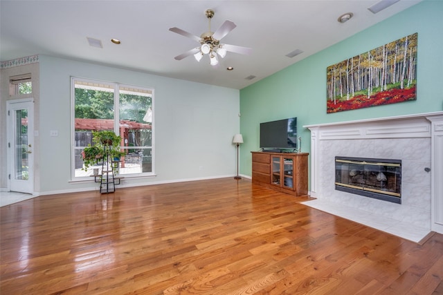2925 Custer Dr, Corinth, TX 76210 - unfurnished living room with wood finished floors, a tile fireplace, and ceiling fan
