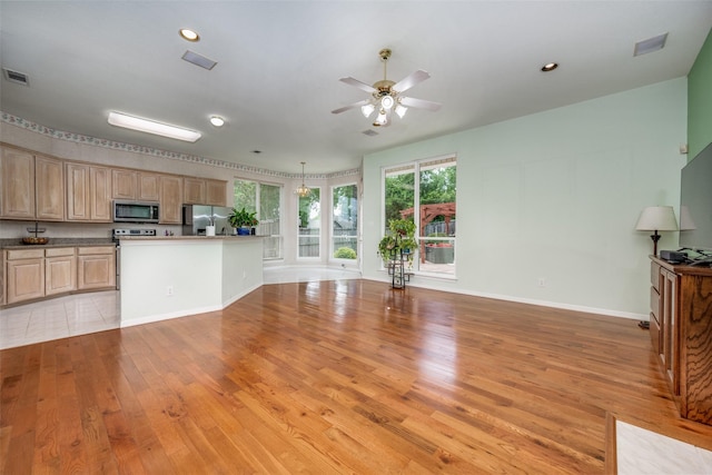 2925 Custer Dr, Corinth, TX 76210 - kitchen with appliances with stainless steel finishes, open floor plan, light wood-style flooring, ceiling fan, and recessed lighting