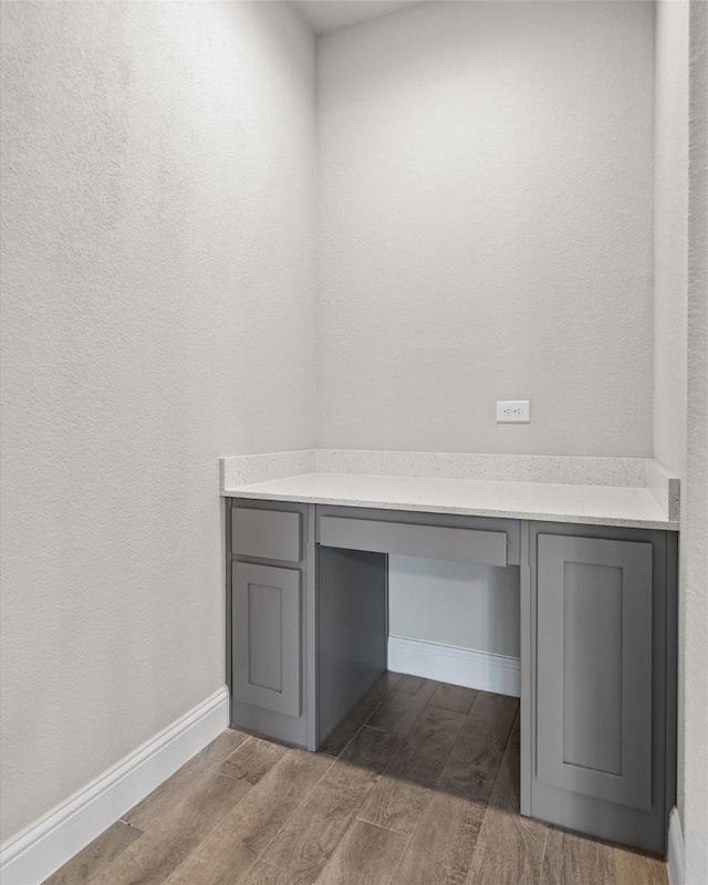 825 Blackhorse Trl, Fort Worth, TX 76247 - unfurnished office featuring dark wood-style flooring, built in study area, and baseboards