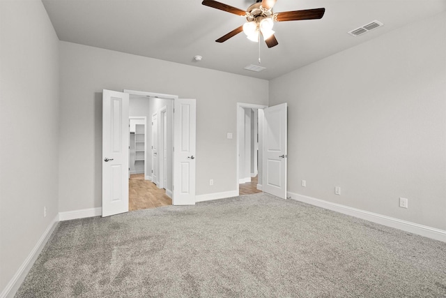 825 Blackhorse Trl, Fort Worth, TX 76247 - unfurnished bedroom with light carpet, baseboards, a spacious closet, and ceiling fan