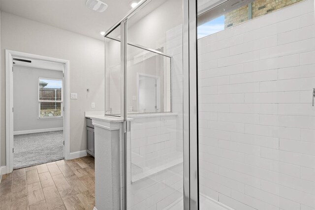 825 Blackhorse Trl, Fort Worth, TX 76247 - bathroom with a stall shower, wood finished floors, vanity, and baseboards