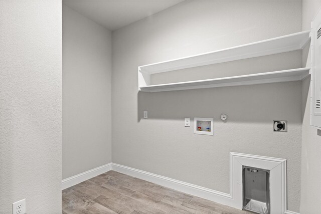 825 Blackhorse Trl, Fort Worth, TX 76247 - laundry room with electric dryer hookup, hookup for a gas dryer, washer hookup, wood finished floors, and baseboards