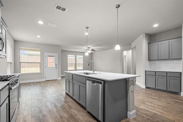 825 Blackhorse Trl, Fort Worth, TX 76247 - kitchen featuring dishwasher, a sink, range with gas stovetop, gray cabinets, and recessed lighting