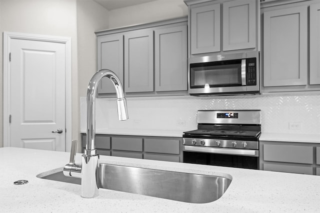 825 Blackhorse Trl, Fort Worth, TX 76247 - kitchen with stainless steel appliances, gray cabinets, and a sink