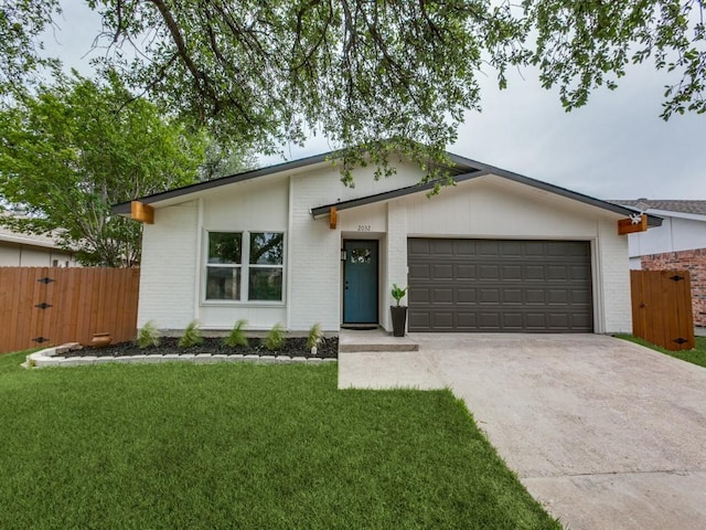 2032 Meadfoot Rd, Carrollton, TX 75007 - view of front of property with brick siding, an attached garage, and driveway