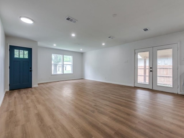 2032 Meadfoot Rd, Carrollton, TX 75007 - unfurnished living room featuring light wood-type flooring, french doors, baseboards, and recessed lighting