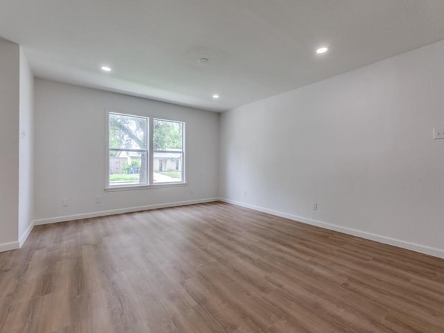 2032 Meadfoot Rd, Carrollton, TX 75007 - unfurnished room with wood finished floors, baseboards, and recessed lighting
