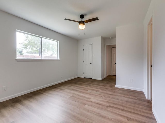2032 Meadfoot Rd, Carrollton, TX 75007 - unfurnished bedroom with light wood finished floors, baseboards, and ceiling fan