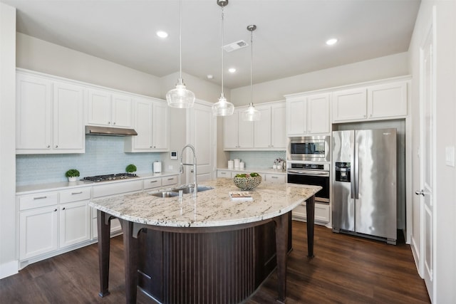 14436 Greymoore Cir, Fort Worth, TX 76008 - kitchen featuring appliances with stainless steel finishes, a sink, a breakfast bar area, under cabinet range hood, and recessed lighting
