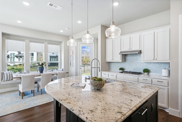 14436 Greymoore Cir, Fort Worth, TX 76008 - kitchen featuring stainless steel gas cooktop, a sink, dark wood finished floors, light stone counters, and white cabinets