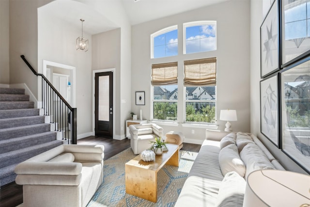 14436 Greymoore Cir, Fort Worth, TX 76008 - living room featuring wood finished floors, baseboards, stairway, a chandelier, and a towering ceiling