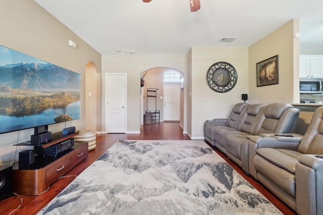 14709 Crystal Lake Dr, Little Elm, TX 75068 - living area featuring arched walkways, dark wood-type flooring, a ceiling fan, and baseboards