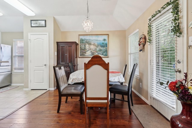 14709 Crystal Lake Dr, Little Elm, TX 75068 - dining room with a chandelier, wood finished floors, and baseboards