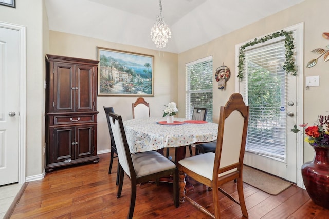 14709 Crystal Lake Dr, Little Elm, TX 75068 - dining area with light wood finished floors, a chandelier, and lofted ceiling