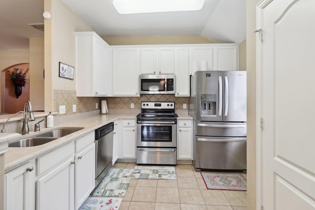 14709 Crystal Lake Dr, Little Elm, TX 75068 - kitchen featuring stainless steel appliances, a sink, backsplash, light countertops, and white cabinets