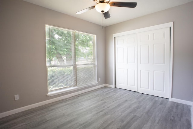 4136 Periwinkle Dr, Fort Worth, TX 76137 - unfurnished bedroom with wood finished floors, baseboards, a closet, and ceiling fan