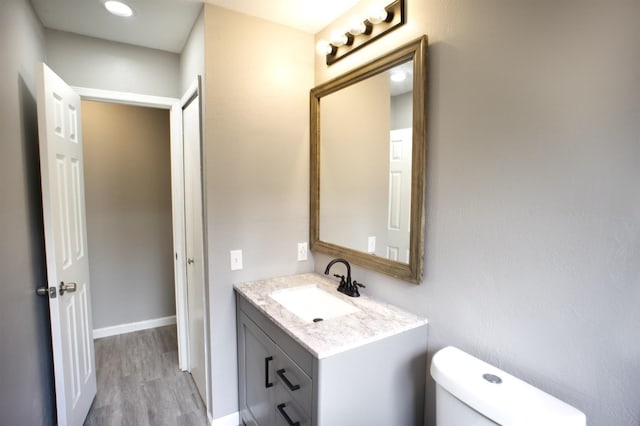 4136 Periwinkle Dr, Fort Worth, TX 76137 - half bath with vanity, toilet, and wood finished floors