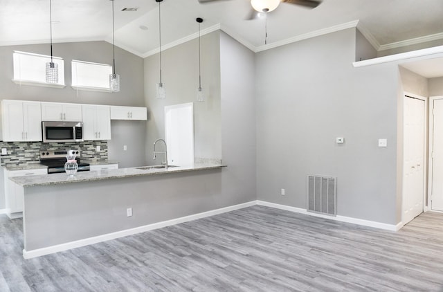 4136 Periwinkle Dr, Fort Worth, TX 76137 - kitchen with stainless steel appliances, a sink, white cabinets, light wood-style floors, and high vaulted ceiling
