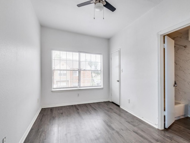 4113 Esters Rd Unit 605, Irving, TX 75038 - unfurnished bedroom with wood finished floors, ceiling fan, and baseboards