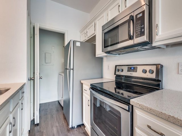 4113 Esters Rd Unit 605, Irving, TX 75038 - kitchen with stainless steel appliances, white cabinets, dark wood-style floors, light stone counters, and washer / clothes dryer