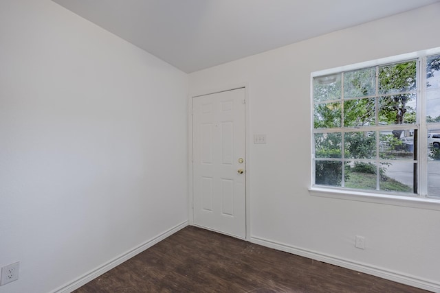 1206 Curtis Dr, Garland, TX 75040 - empty room featuring baseboards, plenty of natural light, and dark wood finished floors