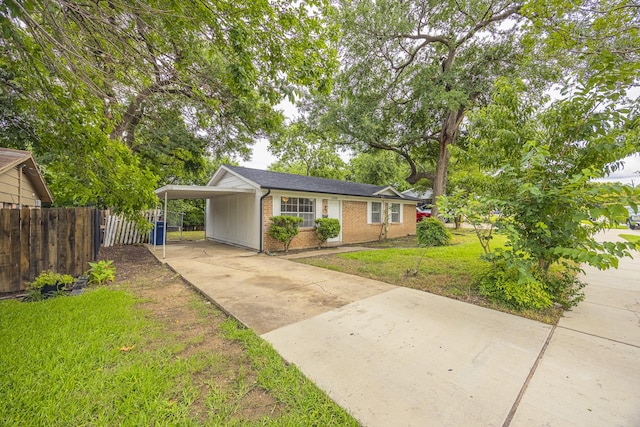 1206 Curtis Dr, Garland, TX 75040 - view of front of house featuring brick siding, concrete driveway, and a carport