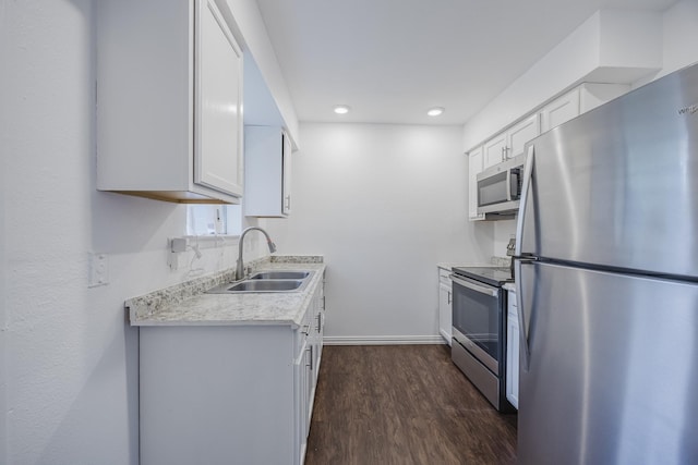 1206 Curtis Dr, Garland, TX 75040 - kitchen featuring stainless steel appliances, a sink, light countertops, baseboards, and dark wood-style floors