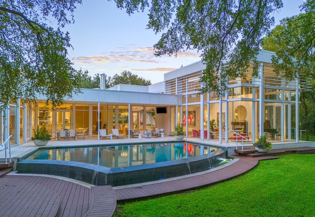 4130 Cochran Chapel, Dallas, TX 75209 - back of property at dusk with a patio, an outdoor pool, and a yard