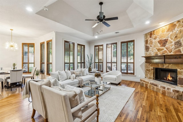 1516 Hawthorne Ln, Keller, TX 76262 - living room featuring plenty of natural light, a tray ceiling, ornamental molding, a fireplace, and ceiling fan