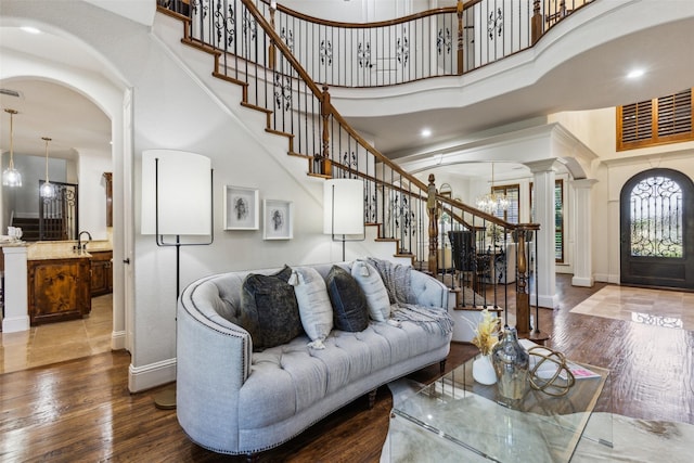 1516 Hawthorne Ln, Keller, TX 76262 - living room featuring decorative columns, stairway, a towering ceiling, arched walkways, and baseboards