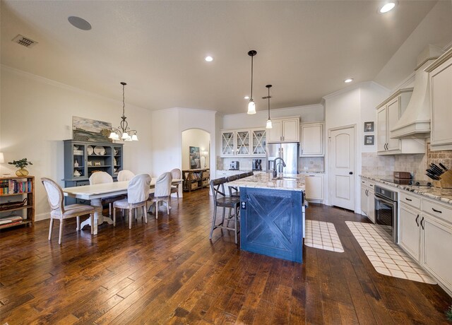 312 Spring Run Dr, Decatur, TX 76234 - kitchen with stainless steel appliances, arched walkways, light stone counters, dark wood finished floors, and recessed lighting