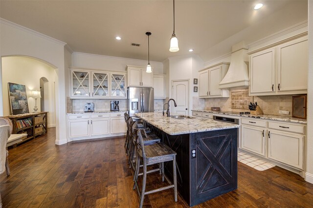 312 Spring Run Dr, Decatur, TX 76234 - kitchen with a sink, stainless steel fridge, custom range hood, dark wood finished floors, and arched walkways