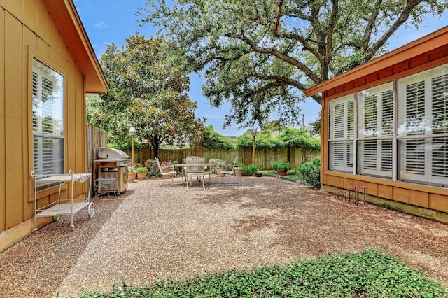 2414 Meadows Ln, Sherman, TX 75092 - fenced backyard featuring area for grilling, a patio area, and outdoor dining area